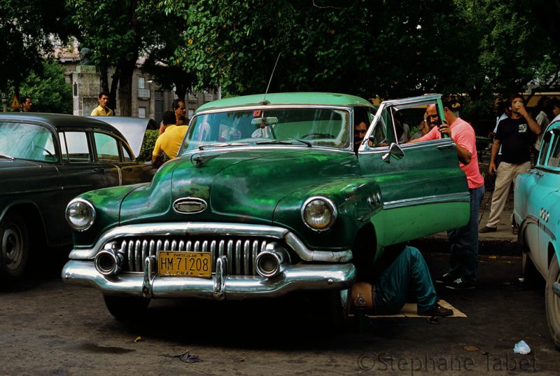 A man repairing a Buick in Havana Cuba