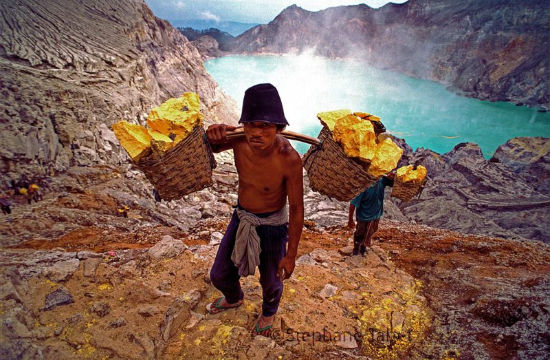 Sulfur miner in Kawah Ijen crater Java Indonesia