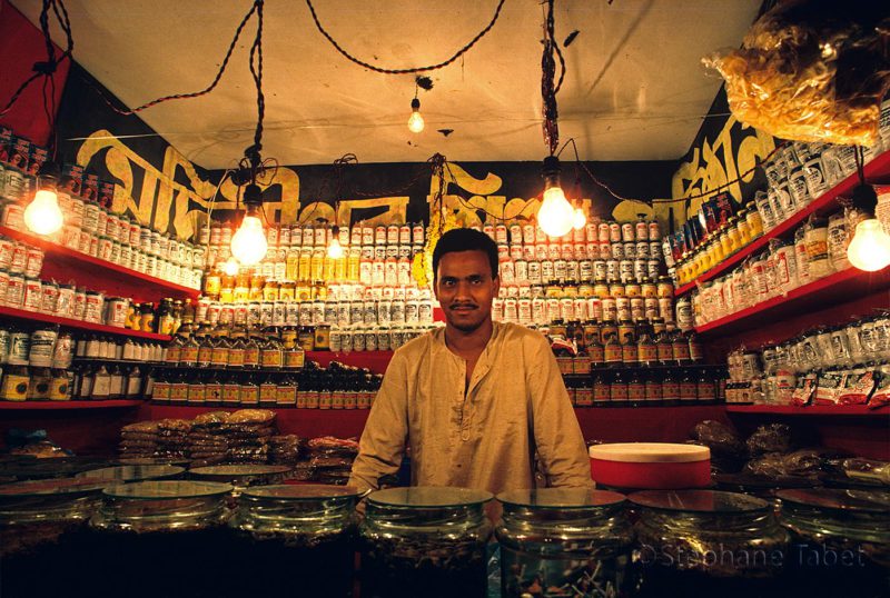 Salesman in a small store in India
