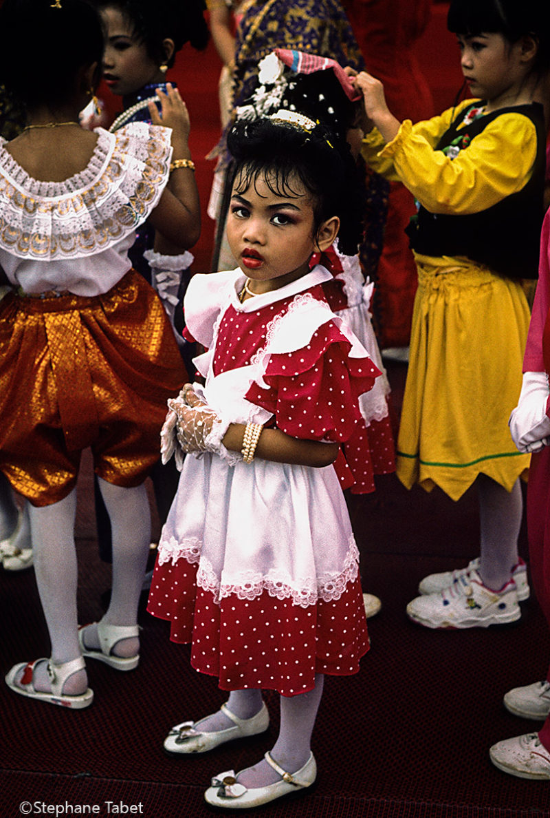 Little girl in traditional dress during festivities in Bangkok Thailand