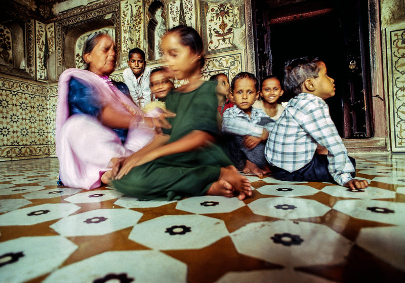 Family and children inside Taj Mahal temple. Agra India